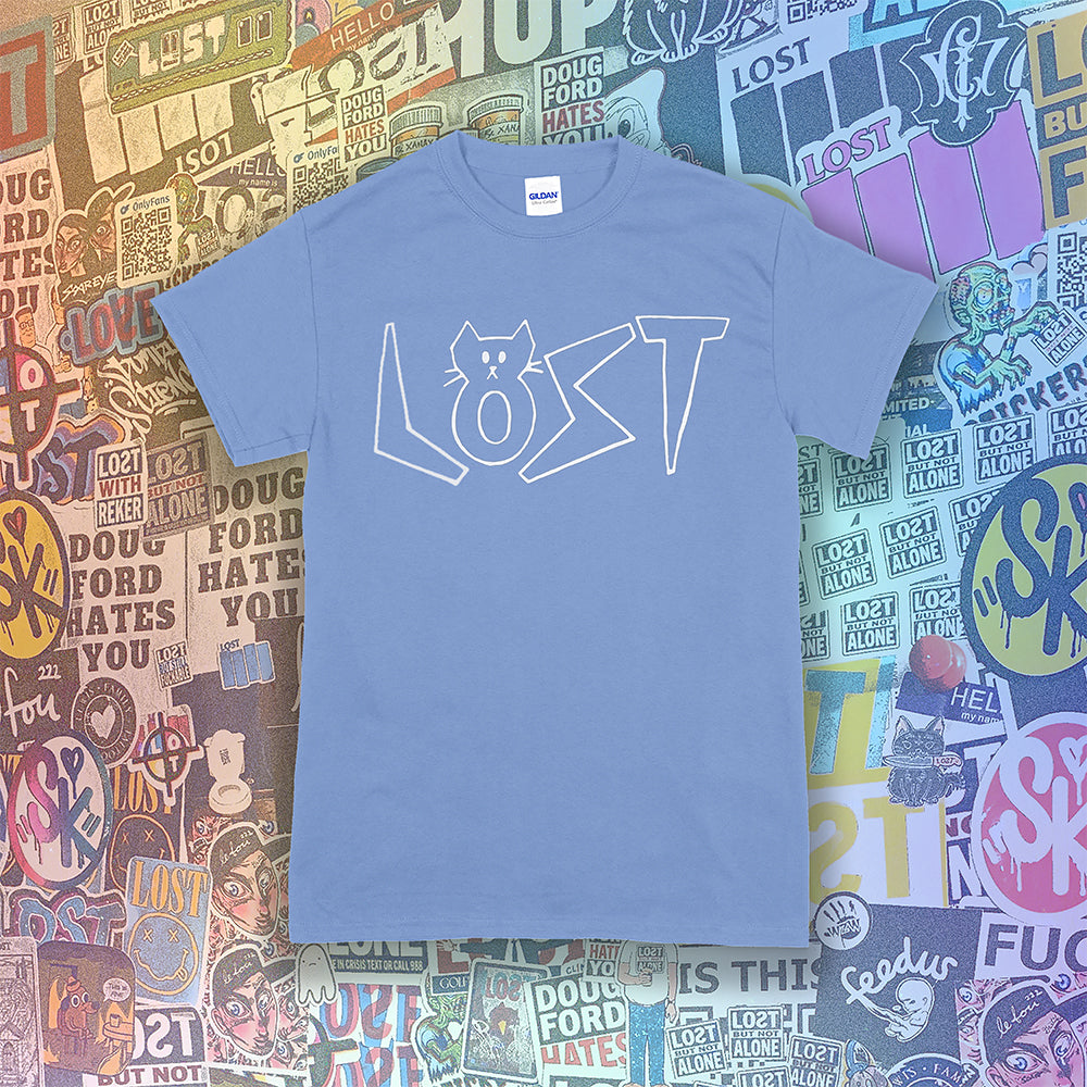 Charlottes White Cat Letters. Hand drawn design of cat shaped letters. Drawn by my daughter Charlotte, and printed with white ink on Carolina blue cotton shirt. Graffiti stickers in the background.