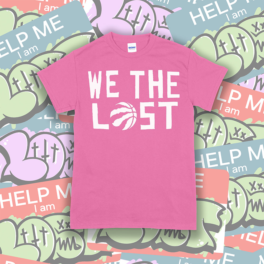 The We The Lost t-shirt. Bold white lettering and raptor claw design screen printed onto a bright pink colored shirt. A collection of brightly colored graffiti stickers makes up the background.