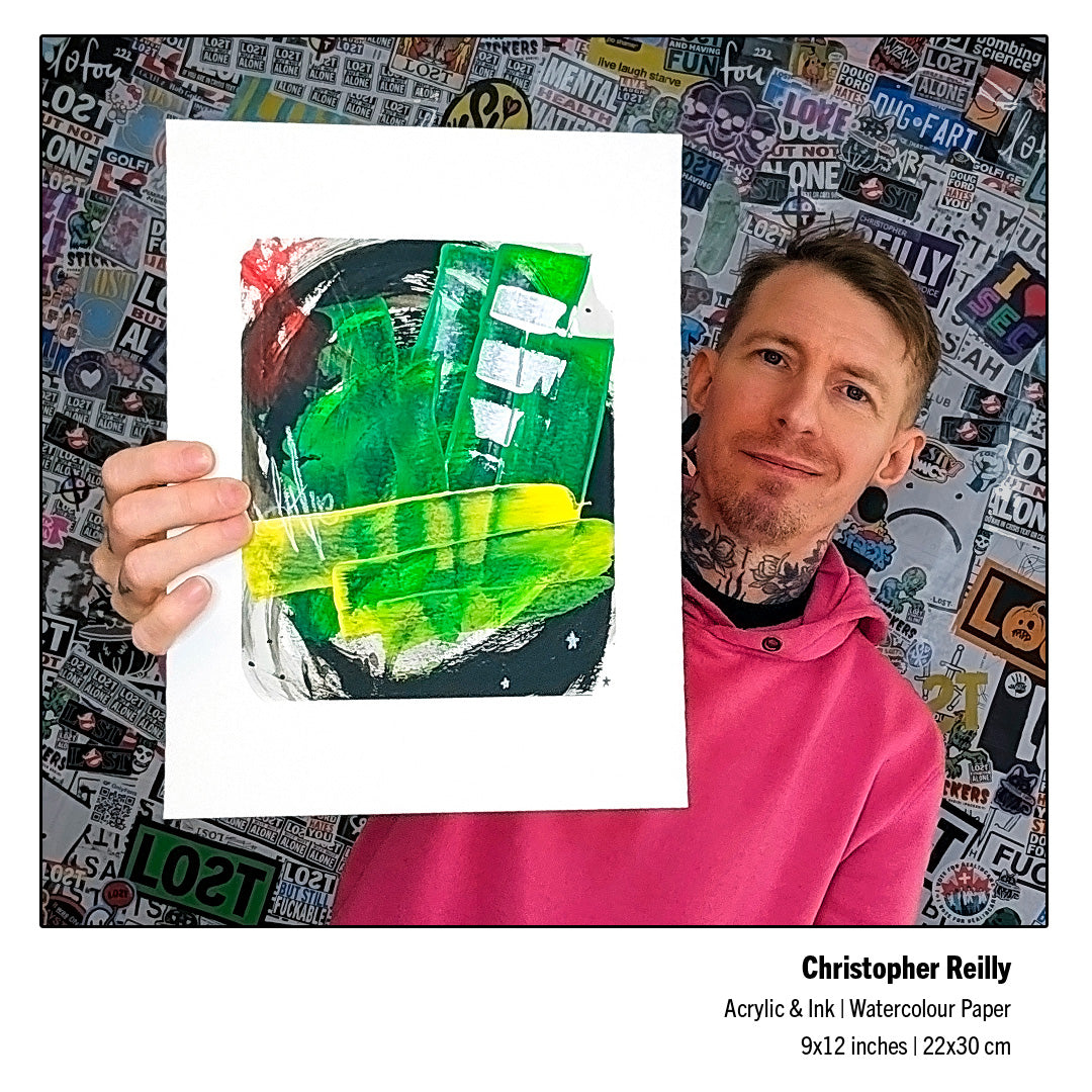 Canadian abstract fine artist Christopher Reilly standing in front of a sticker-covered wall, holding up his completed original 9x12 mixed-media artwork, Painting 260, revealing its physical scale and rich color saturation.