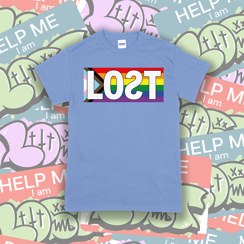 The Progress Flag shirt design by Lost Streetwear. Full color design displayed on a light blue t-shirt. A collage of graffiti stickers provides a creative background for the shirt.